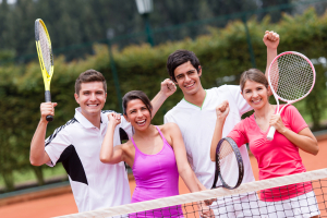 Excited group of tennis players with arms up